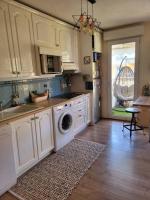 a kitchen with a sink and a washing machine at Une invitation à la détente in Nice