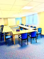 a classroom with tables and chairs and a whiteboard at Hotel de l&#39;Europe in Dieppe