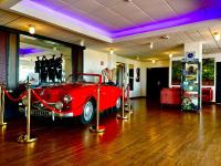 a red car is on display in a room at Hotel de l&#39;Europe in Dieppe