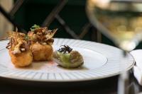 a white plate with some food on a table at Maalot Roma - Small Luxury Hotels of the World in Rome