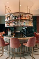 a bar in a restaurant with chairs around it at AKROTHEA suites & lounge in Tripolis