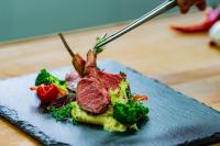 a plate of food with meat and vegetables on a table at Grand Hotel International - Czech Leading Hotels in Prague