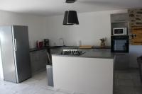 a kitchen with a refrigerator and a counter top at Gîte de charme pour 10 personnes in Camélas