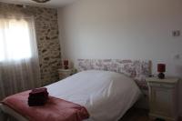 a bedroom with a white bed and a window at Gîte de charme pour 10 personnes in Camélas