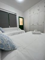 Postel nebo postele na pokoji v ubytování Cangrejo House in Famara, Super Wifi