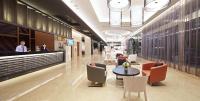 a lobby with a restaurant with a table and chairs at Guanko Hotel in Chiayi City