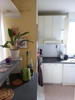 a kitchen with white cabinets and a counter top at Kat&#39;s - Roman Salona in Solin