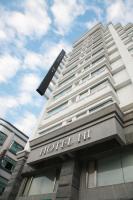 a hotel building with a sign on top of it at HOTEL HI - Xinmin in Chiayi City