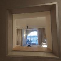 a room with a view of a bedroom with a window at Hotel & Spa Blau Parc in San Antonio