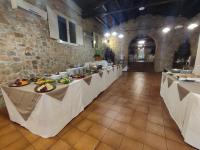 a row of tables in a room with food on them at Allegroitalia Torre Artale Palermo in Trabia