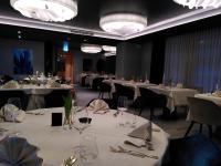 a dining room with white tables and chairs with wine glasses at Hotel Sonne Sissach in Sissach