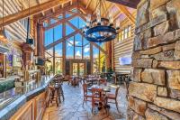 a restaurant with a bar and a stone wall at Mountain Lodge Telluride in Telluride