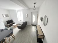 a living room with white walls and a table and chairs at 180A - Duplex T2 Tout Confort du Gond - 45 m2 in Le Gond-Pontouvre