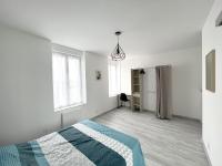 a white bedroom with a bed and a window at 180A - Duplex T2 Tout Confort du Gond - 45 m2 in Le Gond-Pontouvre
