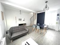 a living room with a couch and a table at 180A - Duplex T2 Tout Confort du Gond - 45 m2 in Le Gond-Pontouvre