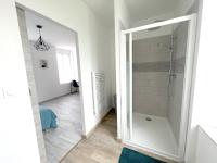 a bathroom with a walk in shower and a mirror at 180A - Duplex T2 Tout Confort du Gond - 45 m2 in Le Gond-Pontouvre