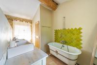 a bathroom with a large tub and a sink at Villa de 6 chambres avec piscine privee jardin clos et wifi a Saignon in Saignon