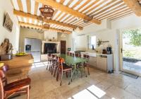 a kitchen and dining room with a green table and chairs at Villa de 6 chambres avec piscine privee jardin clos et wifi a Saignon in Saignon