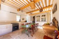 a kitchen with a table and chairs in a room at Villa de 6 chambres avec piscine privee jardin clos et wifi a Saignon in Saignon