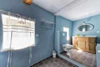 a blue bathroom with a toilet and a sink at Villa de 6 chambres avec piscine privee jardin clos et wifi a Saignon in Saignon