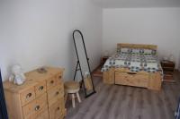 a bedroom with a bed and a wooden dresser at APPARTEMENT NEUF ET INDÉPENDANT DANS REZ-DE-VILLA in Vallauris