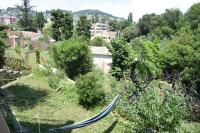 a hammock in a garden with bushes and trees at APPARTEMENT NEUF ET INDÉPENDANT DANS REZ-DE-VILLA in Vallauris