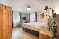 A bed or beds in a room at Das Grüne Hotel zur Post - 100 % BIO