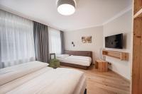 A bed or beds in a room at Das Grüne Hotel zur Post - 100 % BIO