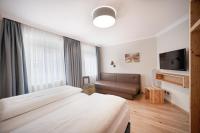 A bed or beds in a room at Das Grüne Hotel zur Post - 100 % BIO