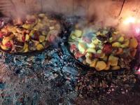 two pans of food are cooking on a fire at Zmaj Ognjeni Etno Concept in Kupinovo