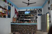a bar in a room with a ceiling fan at Bardia Wild Side Hotel in Bhurkīā