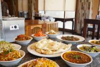 a table topped with bowls of different types of food at NUMINOUS HOTEL in Thimphu