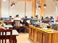 a group of people sitting at tables in a restaurant at NUMINOUS HOTEL in Thimphu