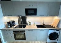 a kitchen with a sink and a stove top oven at Panorama des Chartrons in Bordeaux