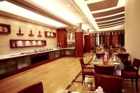 a restaurant with tables and chairs and a bar at DLF Club 3 in Gurgaon