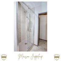 a shower with a glass door in a bathroom at Château de Laforest - Les Hébergements in Thizy-les-Bourgs