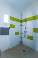 a bathroom with green and white stripes on the wall at Village Drôles d&#39;Oiseaux in Le Teich