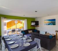 a dining room with a table with plates and wine glasses at Village Drôles d&#39;Oiseaux in Le Teich