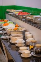 a buffet line with plates and bowls of food at Cat Ba Wonder Hotel in Cat Ba