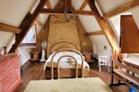 a bedroom with a large bed in a attic at Maison périgourdine avec vue et piscine chauffée in Peyzac-le-Moustier
