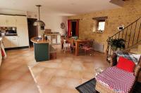 a living room with a kitchen and a dining room at Maison périgourdine avec vue et piscine chauffée in Peyzac-le-Moustier