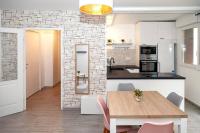 a kitchen and dining room with a wooden table at Appartement cosy à 10 min de Disneyland Paris ! in Montévrain