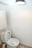 a bathroom with a toilet with a light above it at Appartement cosy à 10 min de Disneyland Paris ! in Montévrain