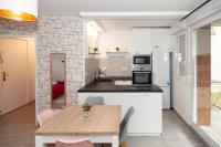 a kitchen and dining room with a wooden table at Appartement cosy à 10 min de Disneyland Paris ! in Montévrain