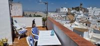 a table and chairs on a balcony with a view at Holiday home La Atalaya de Vejer in Vejer de la Frontera