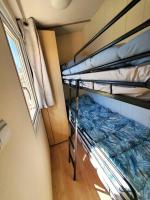 a small room with two bunk beds in it at Bungalow L&#39;Estagnol - 3 chambres in Sigean