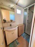 a small bathroom with a sink and a shower at Bungalow L&#39;Estagnol - 3 chambres in Sigean