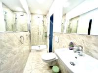 a bathroom with a sink and a toilet and a shower at VILLA ORCHARD Frankfurt in Zeilsheim