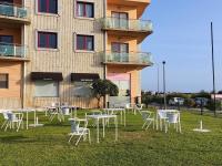a group of tables and chairs in front of a building at The Surf Studio - Ericeira in Ericeira