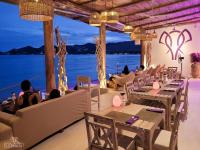 a restaurant with tables and a view of the water at Elephant Beach Club & Resort Samui in Chaweng